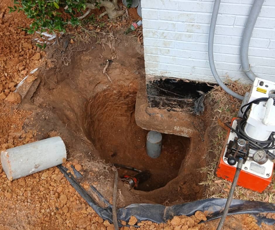 Press pier foundation repair beneath a home in Longview, Texas